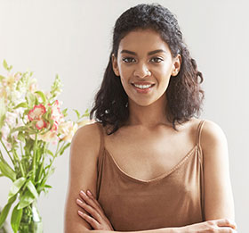 Young woman smiling with her arms crossed